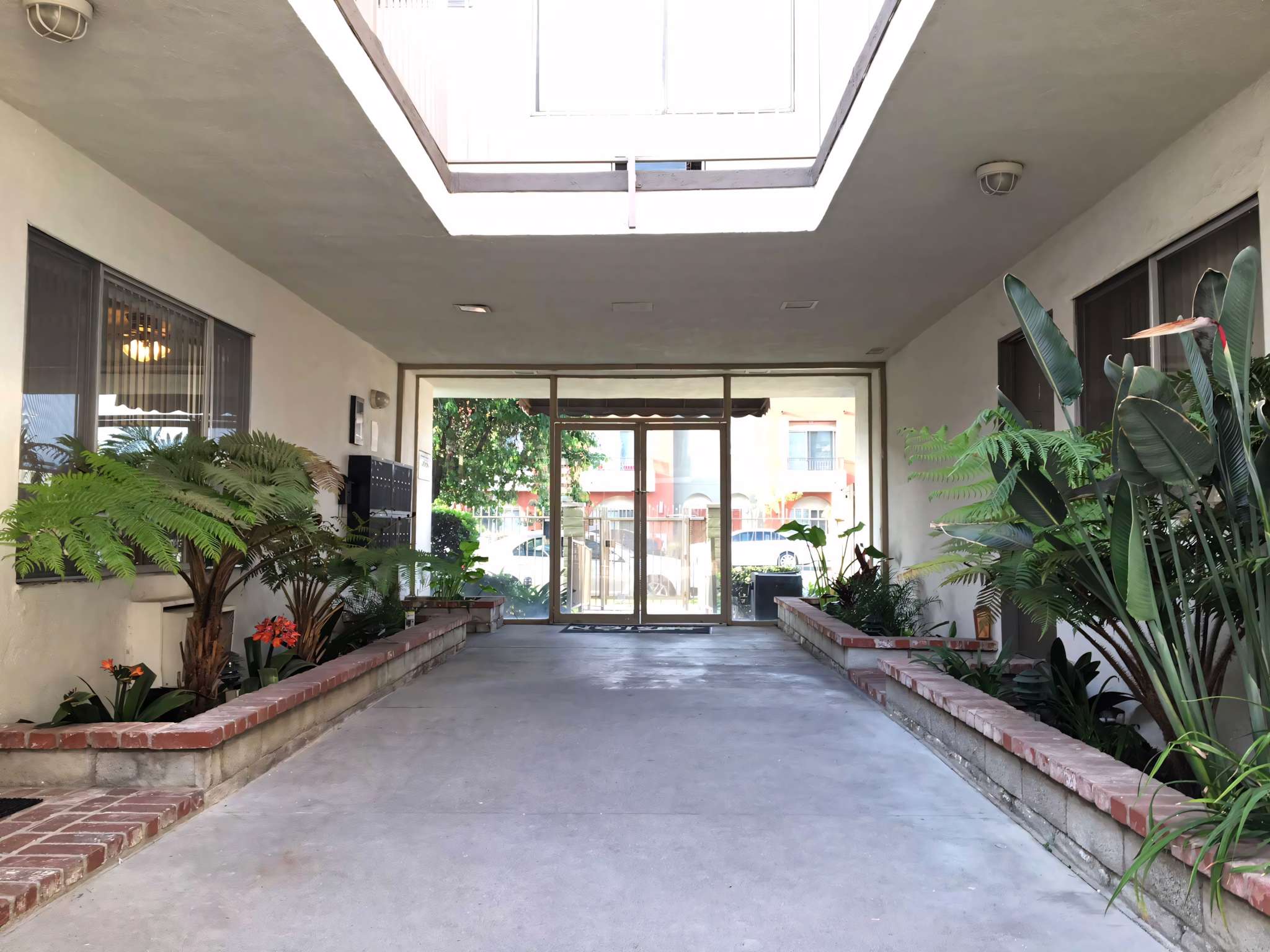SF Valley Collection open air breezeway entrance with tropical landscaping