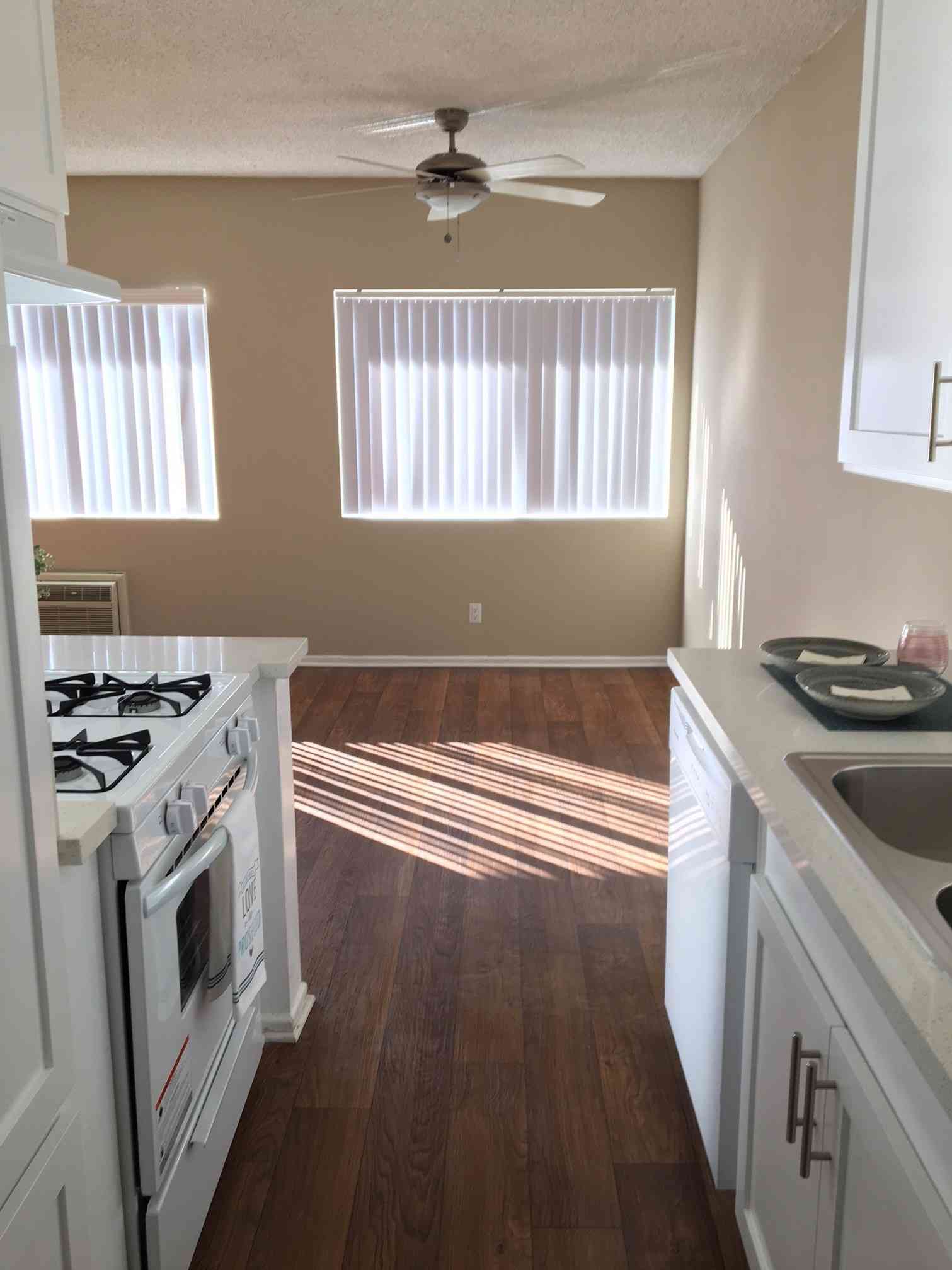 open concept kitchen view to hardwood style flooring