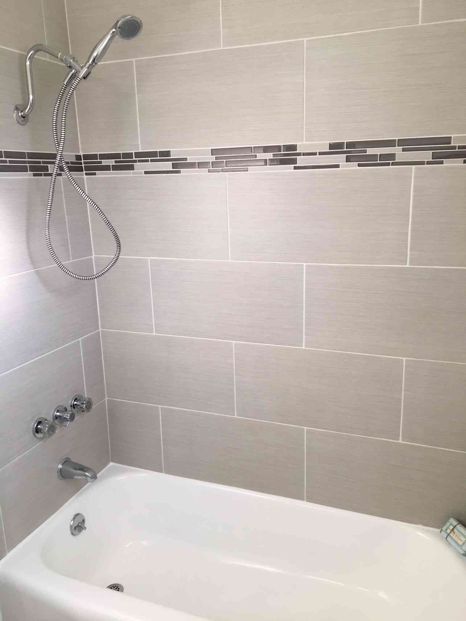 modern shower with decorative tile surround